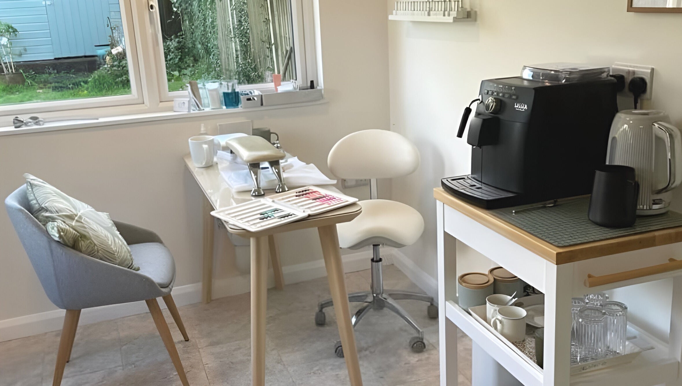 Cozy beauty corner at The Rose Room, Westergate, England, with chairs and coffee machine.