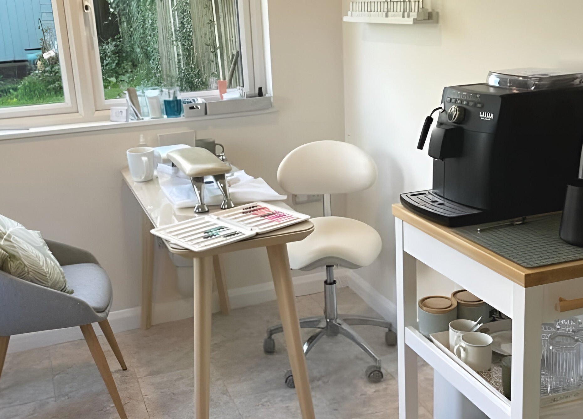 Cozy beauty corner at The Rose Room, Westergate, England, with chairs and coffee machine.