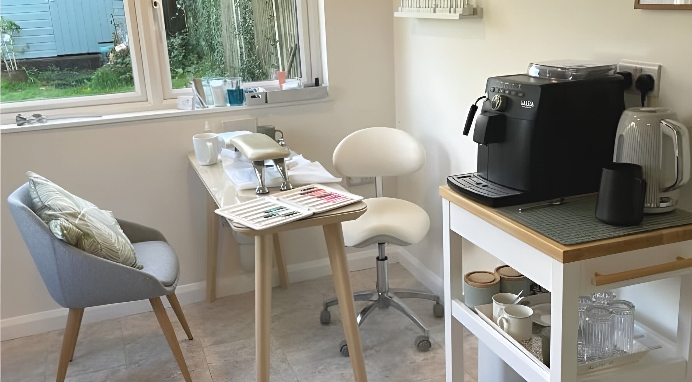 Cozy beauty corner at The Rose Room, Westergate, England, with chairs and coffee machine.