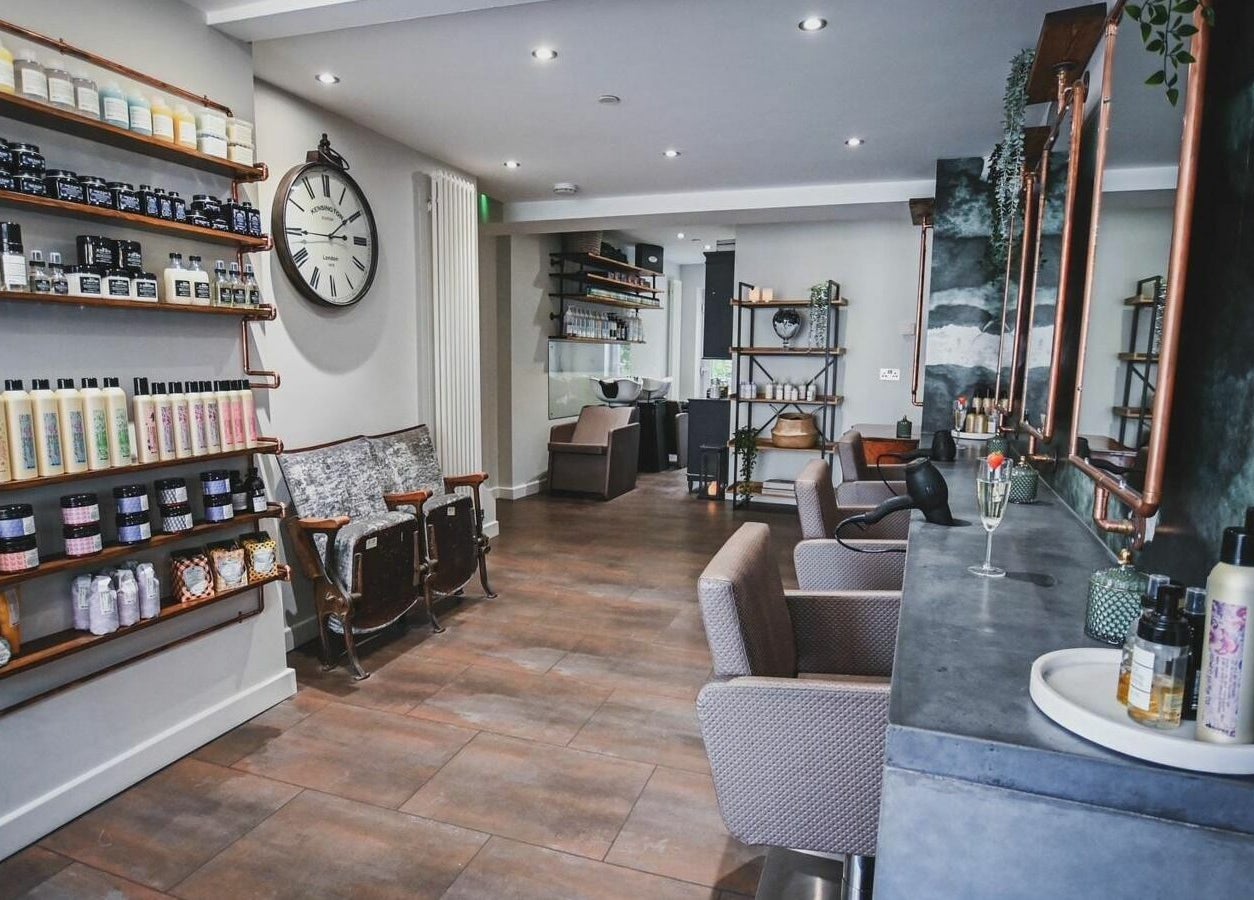 Modern interior of Oliver's Hair Studio Limited, Belper, England, GB, featuring stylish chairs and beauty products.