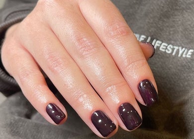 Elegant dark plum manicure at Mimi-Jo Beauty in Scarborough, England, GB showcasing nail artistry.