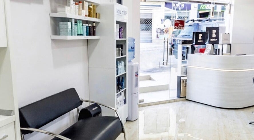 Modern interior of TONI&GUY Ibrag in Is-swieqi, MT with sleek seating and product displays.