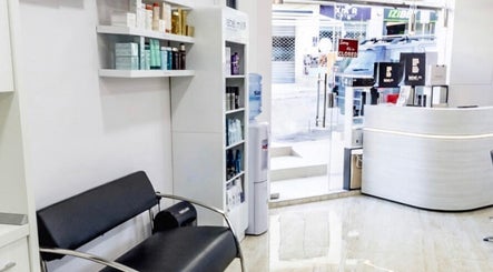 Modern salon reception at TONI&GUY Ibrag, Is-swieqi, MT featuring sleek seating and product shelves.