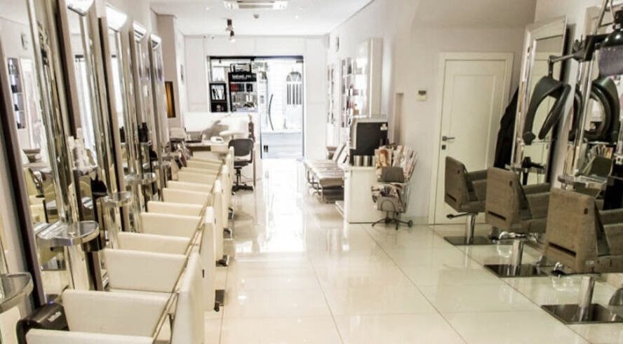 Modern interior of TONI&GUY Gzira salon in Gzira, MT, showcasing stylish chairs and sleek mirrors.