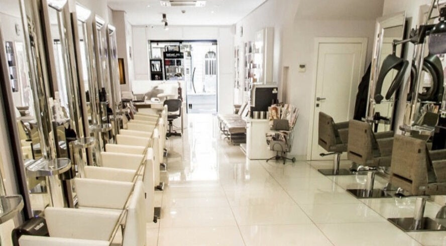 Modern interior of TONI&GUY Gzira salon in Gzira, MT, showcasing stylish chairs and sleek mirrors.