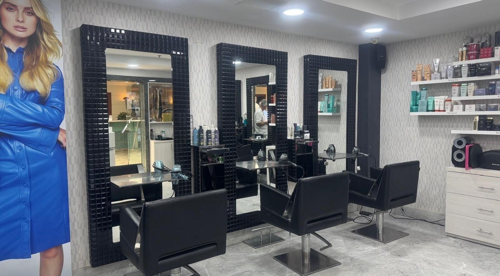 Modern salon setup with mirrors and chairs inside TONI&GUY Hilton, San Ġiljan, MT.