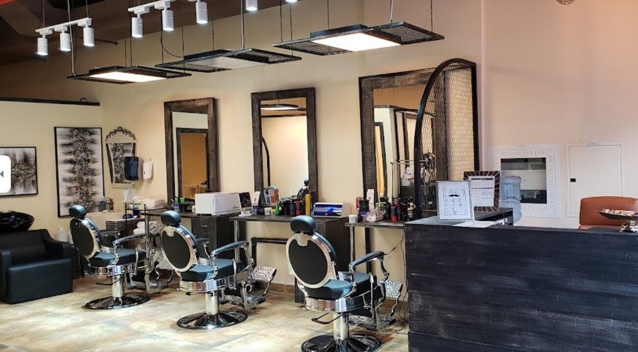 Interior of Capelli Da Festa Gents Saloon in Dubai, Dubai, AE featuring modern barber chairs and sleek decor.
