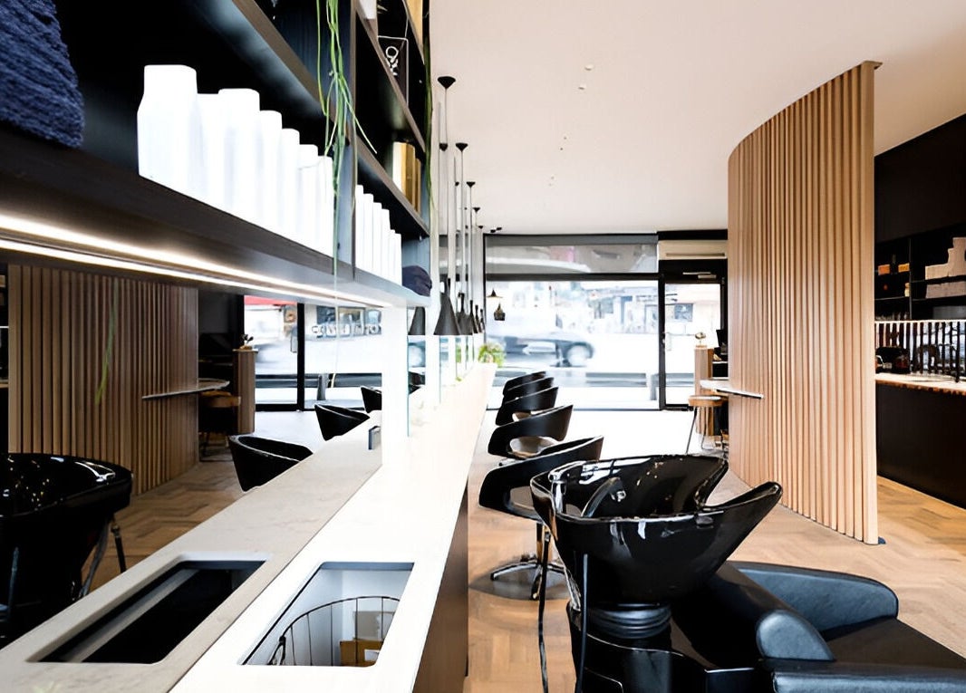 Modern interior at Covet & Co, Melbourne, Victoria, AU featuring sleek salon stations and stylish decor.