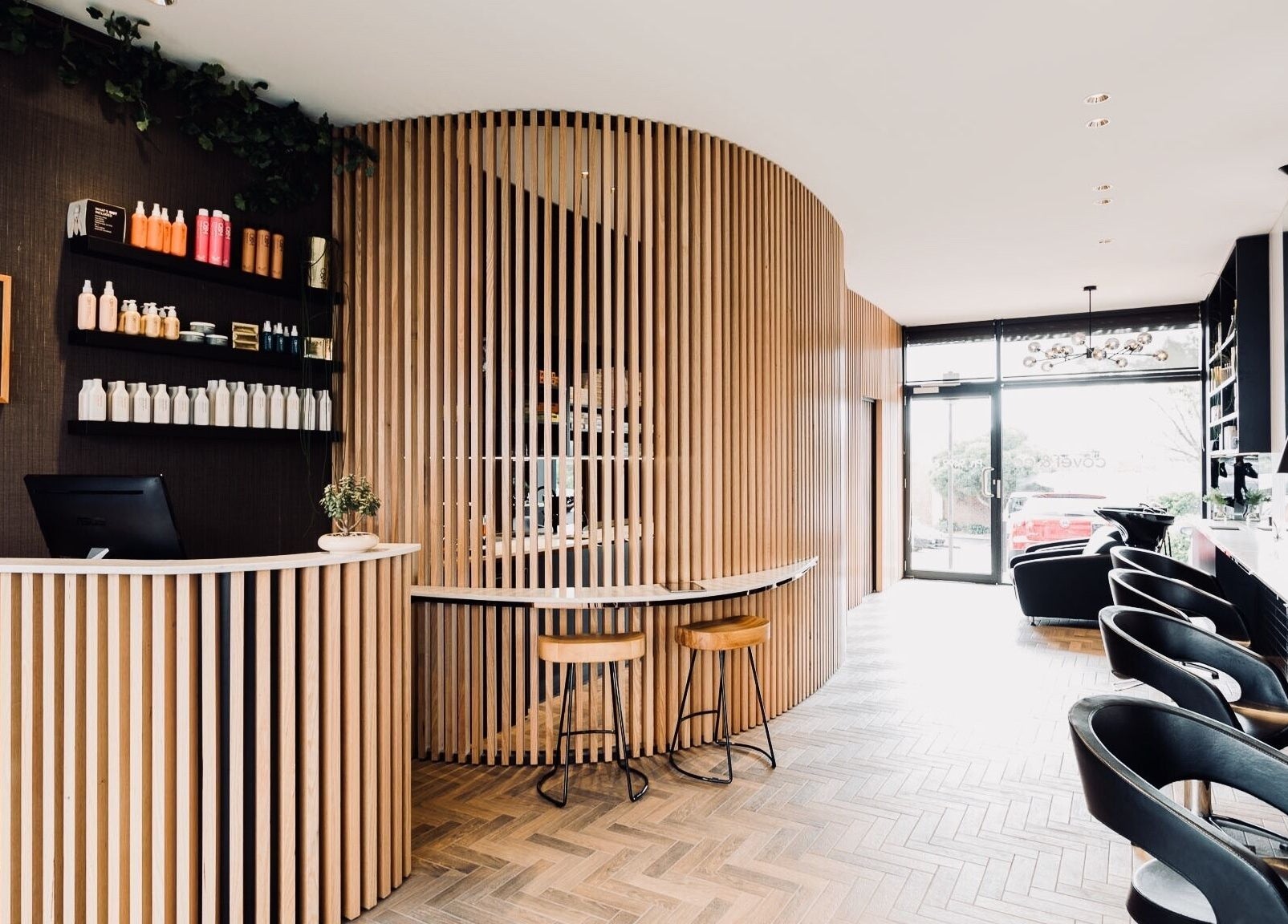 Modern reception area at Covet & Co, Melbourne, Victoria, AU with stylish wooden decor and comfortable seating.