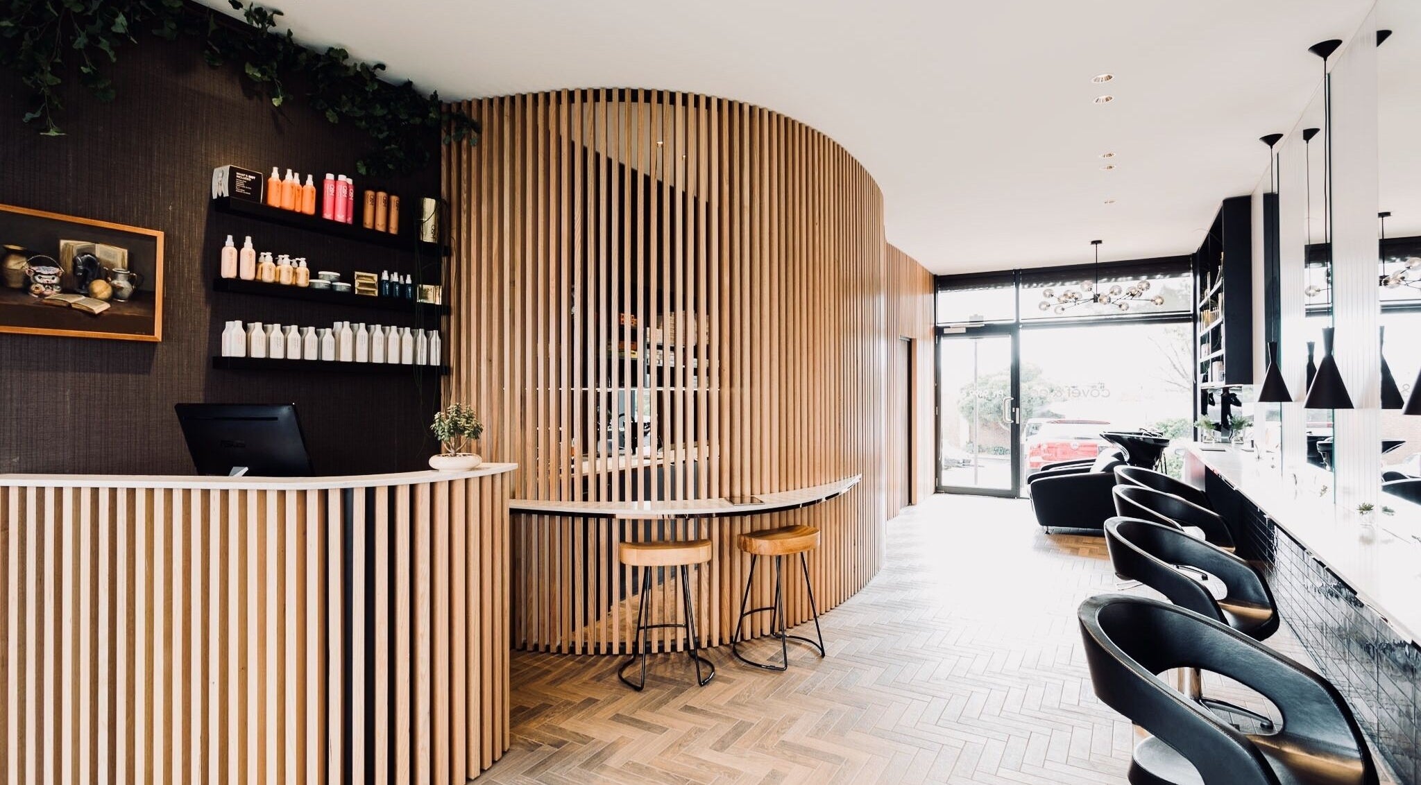 Modern reception area at Covet & Co, Melbourne, Victoria, AU with stylish wooden decor and comfortable seating.