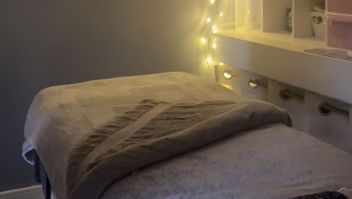 Cozy massage table with warm lighting at Secret Garden Spa, Gartcosh, Scotland, GB.