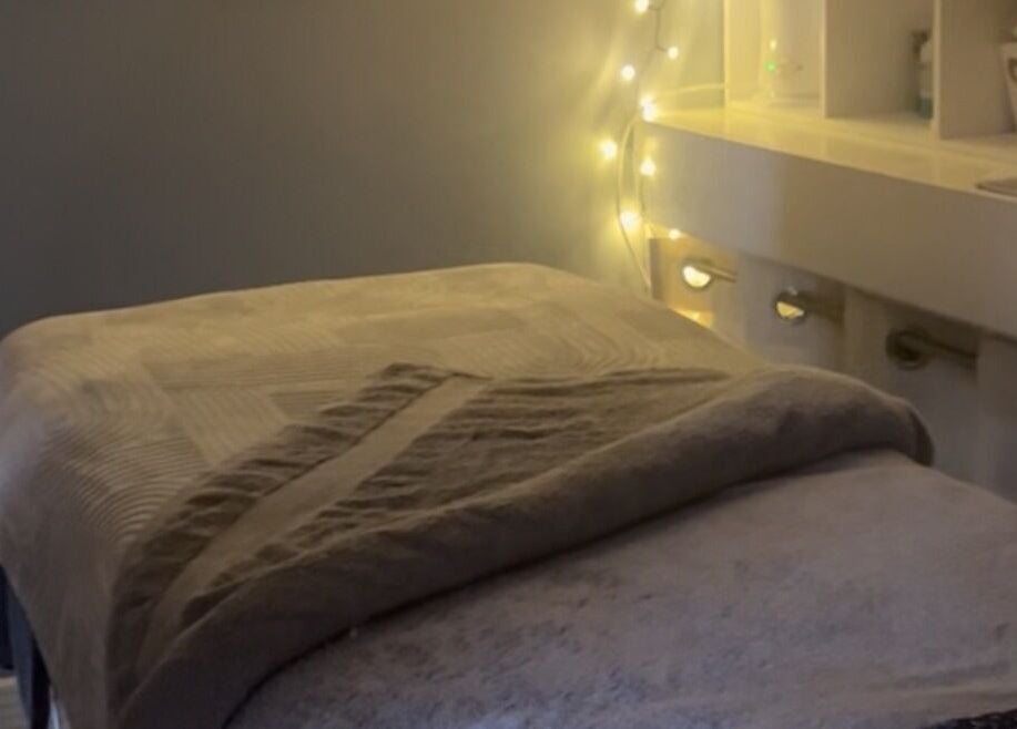 Cozy massage table with warm lighting at Secret Garden Spa, Gartcosh, Scotland, GB.