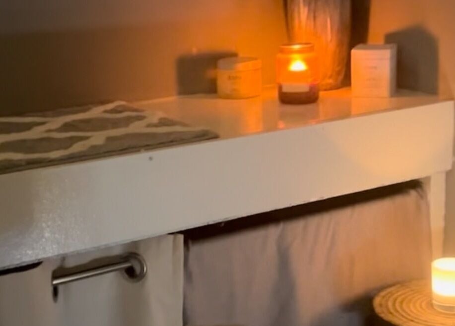 Cozy candlelit massage room at Secret Garden Spa, Gartcosh, Scotland, GB enhancing relaxation and tranquility.