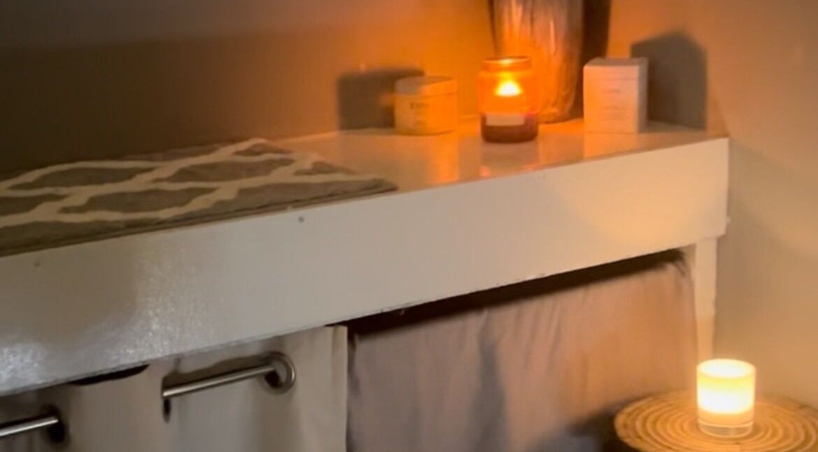 Cozy candlelit massage room at Secret Garden Spa, Gartcosh, Scotland, GB enhancing relaxation and tranquility.