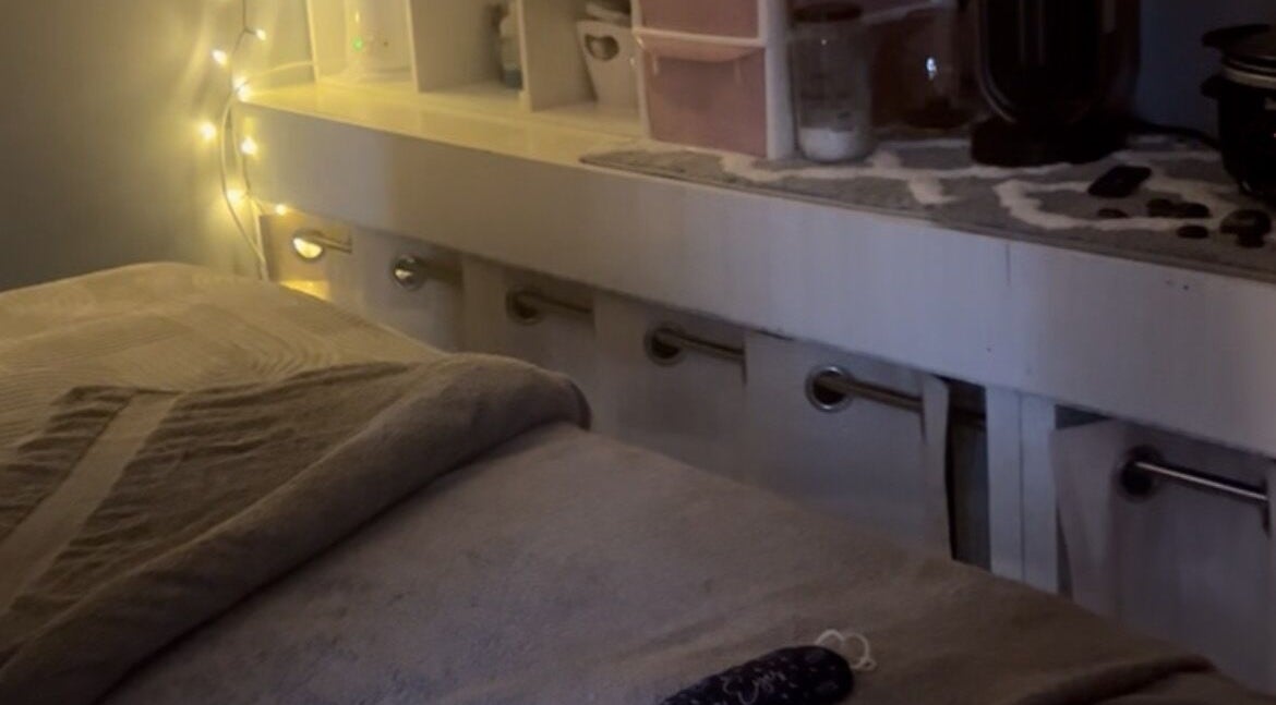 Serene massage table in Secret Garden Spa, Gartcosh, Scotland, GB showcases ambient lighting.