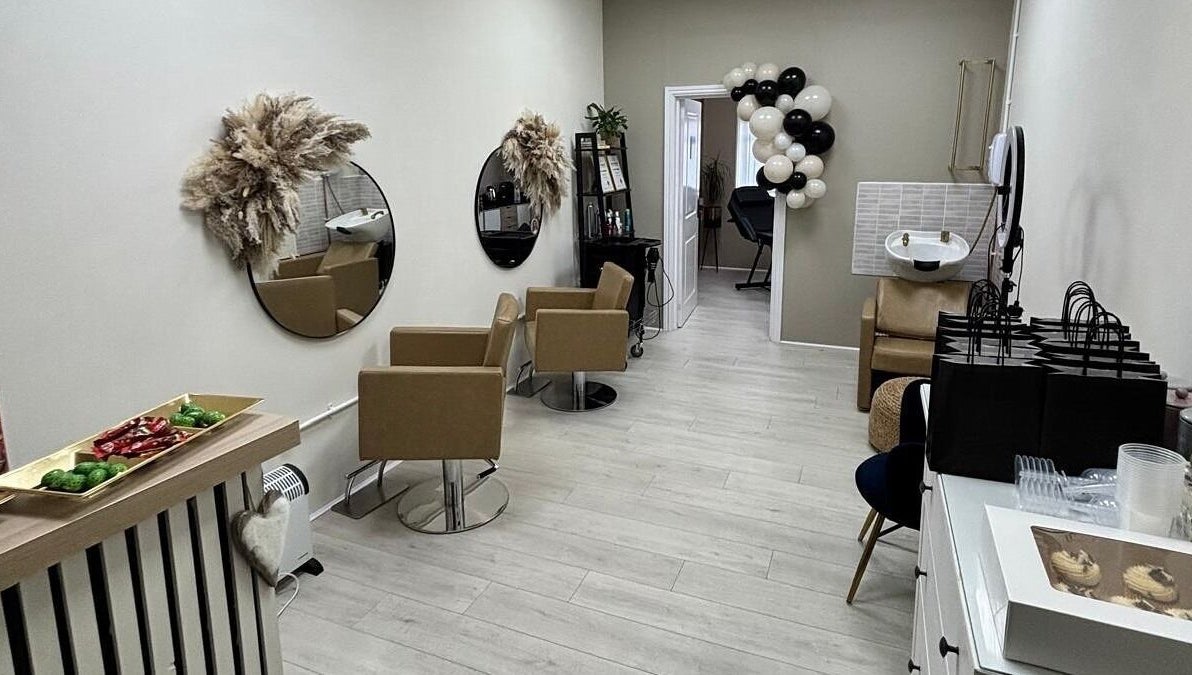 Elegant interior of 11:11 Hairdressing in Wrexham, Wales, GB with stylish chairs and decor.