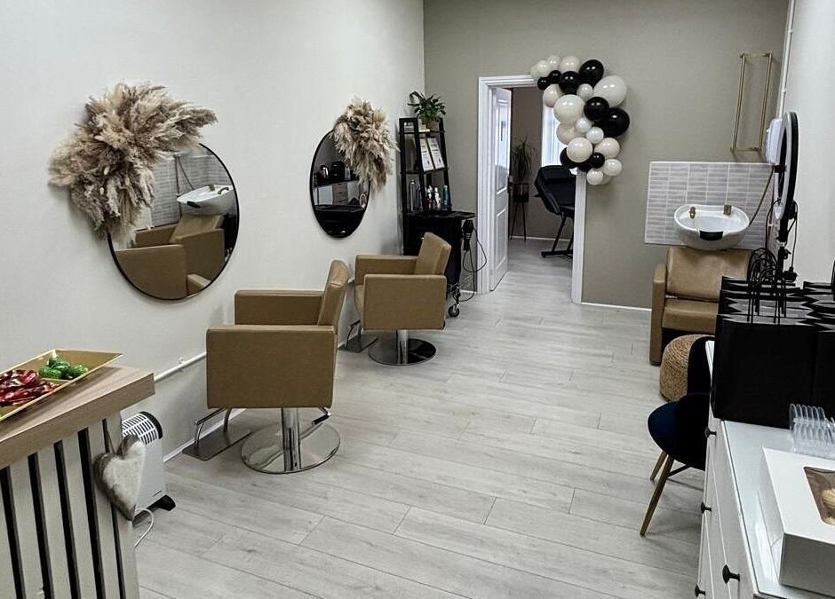 Elegant interior of 11:11 Hairdressing in Wrexham, Wales, GB with stylish chairs and decor.