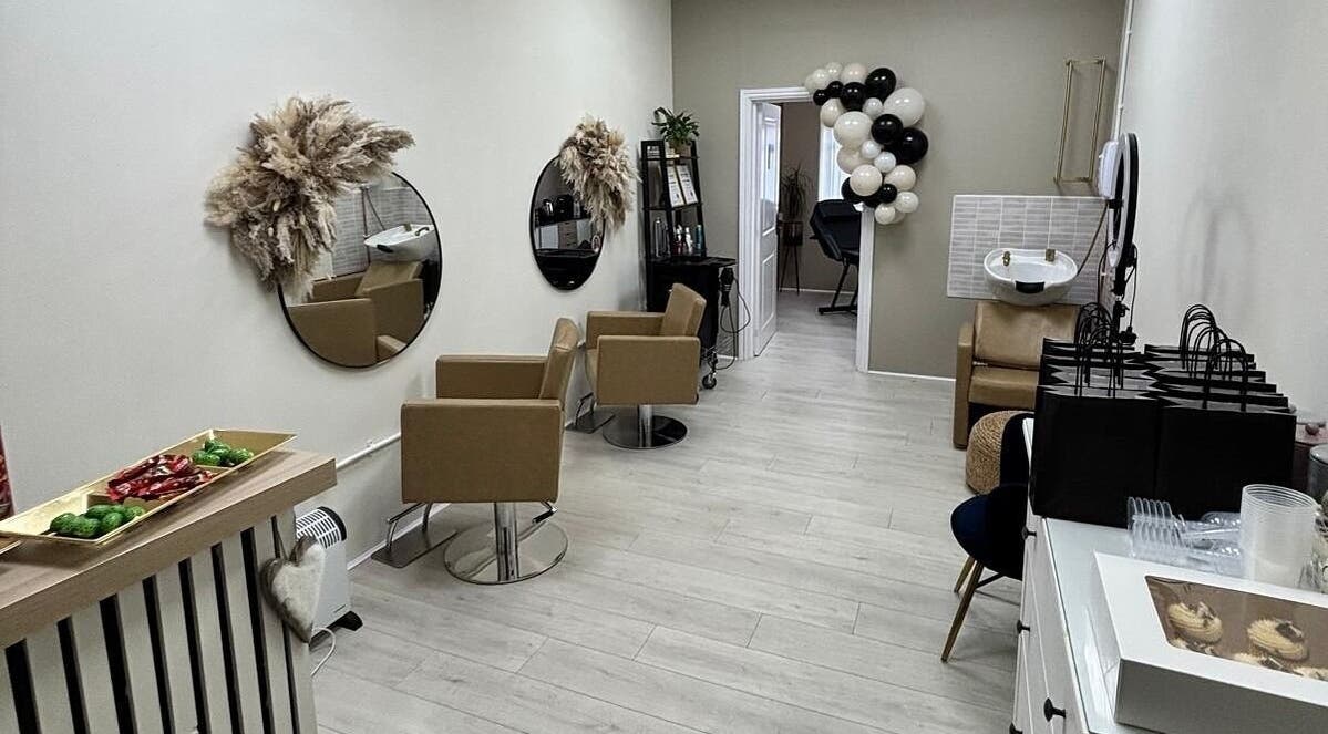Elegant interior of 11:11 Hairdressing in Wrexham, Wales, GB with stylish chairs and decor.