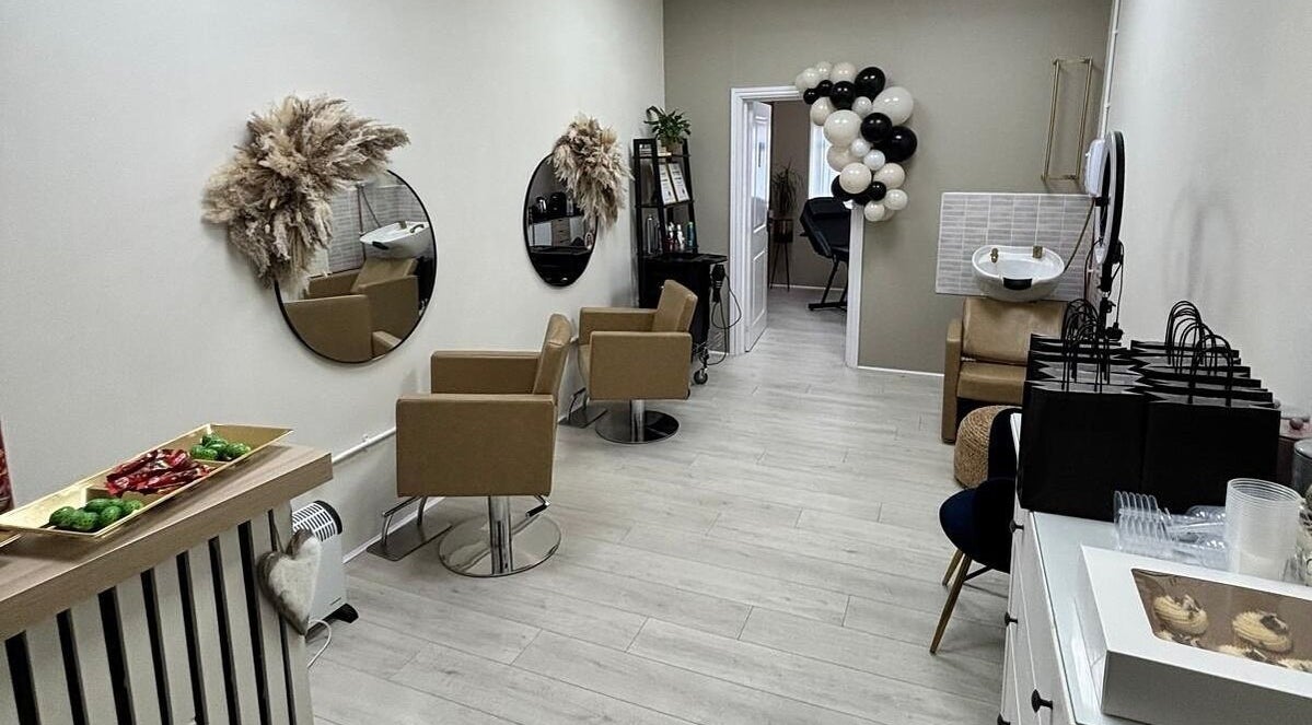 Elegant interior of 11:11 Hairdressing in Wrexham, Wales, GB with stylish chairs and decor.