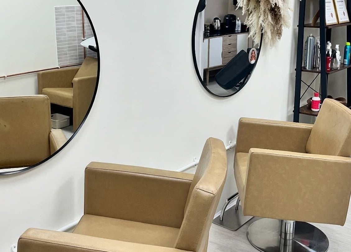 Modern hairdressing chairs and mirrors at 11:11 Hairdressing in Wrexham, Wales, GB showcasing a sleek interior.