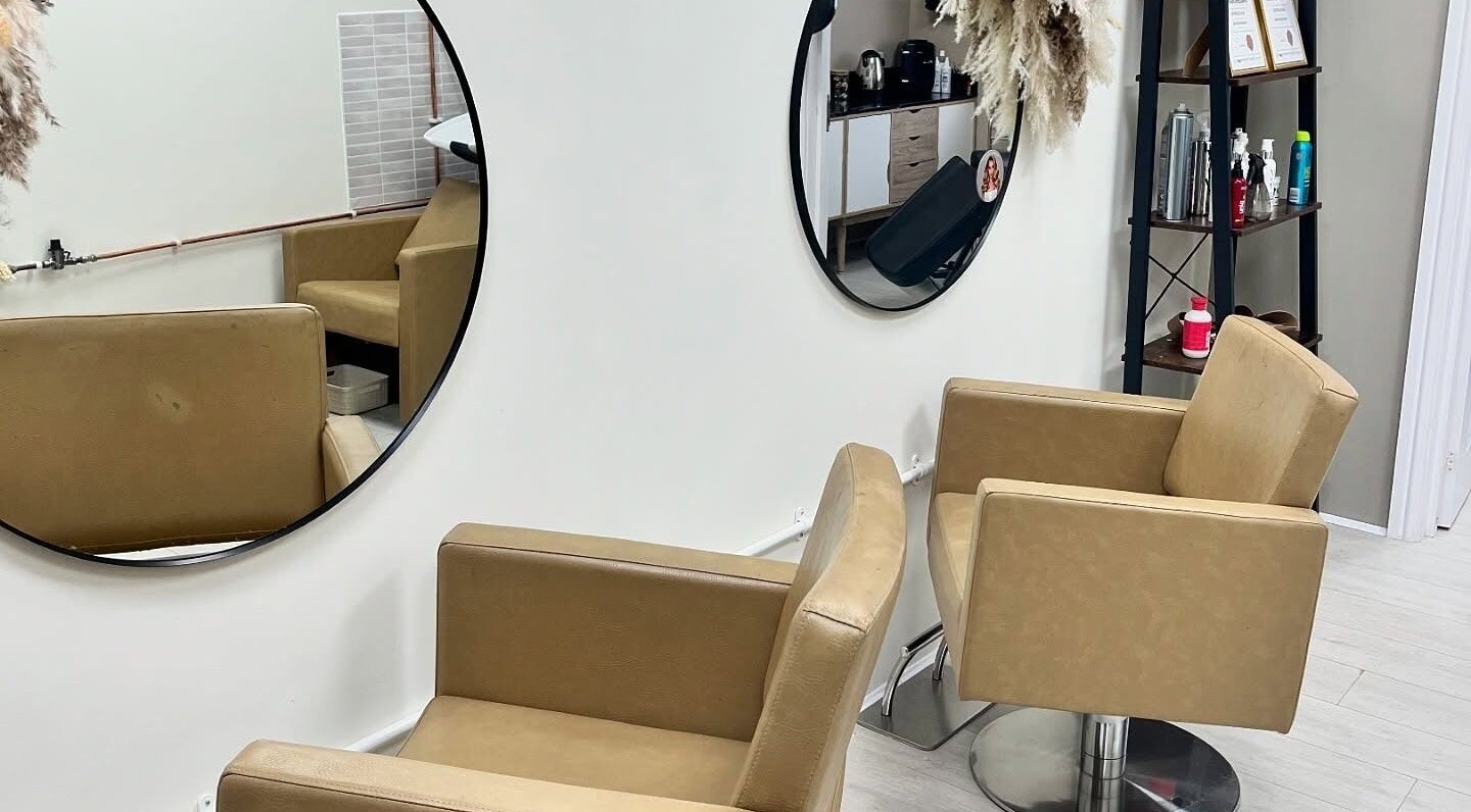 Modern hairdressing chairs and mirrors at 11:11 Hairdressing in Wrexham, Wales, GB showcasing a sleek interior.