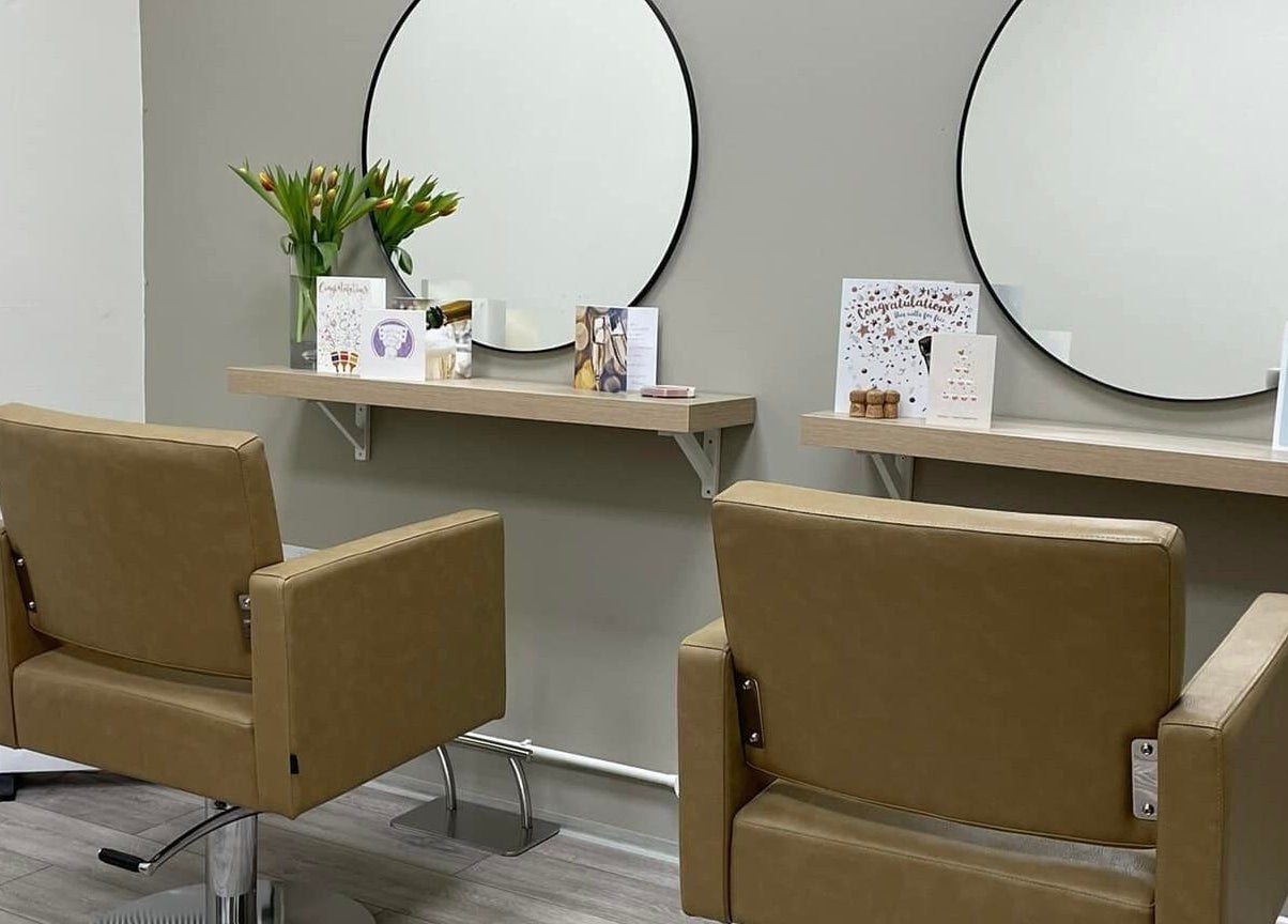 Modern styling chairs and mirrors at 11:11 Hairdressing in Wrexham, Wales, GB, creating a stylish salon vibe.