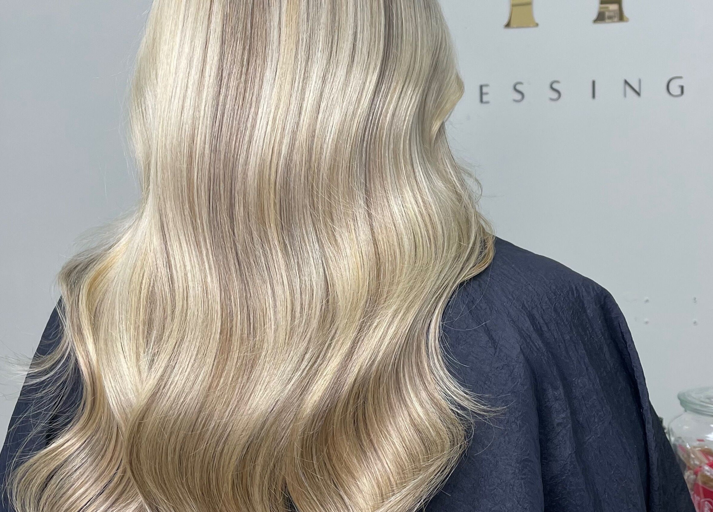 Elegant blonde waves styled at 11:11 Hairdressing, Wrexham, Wales, GB, showcasing expert craftsmanship.