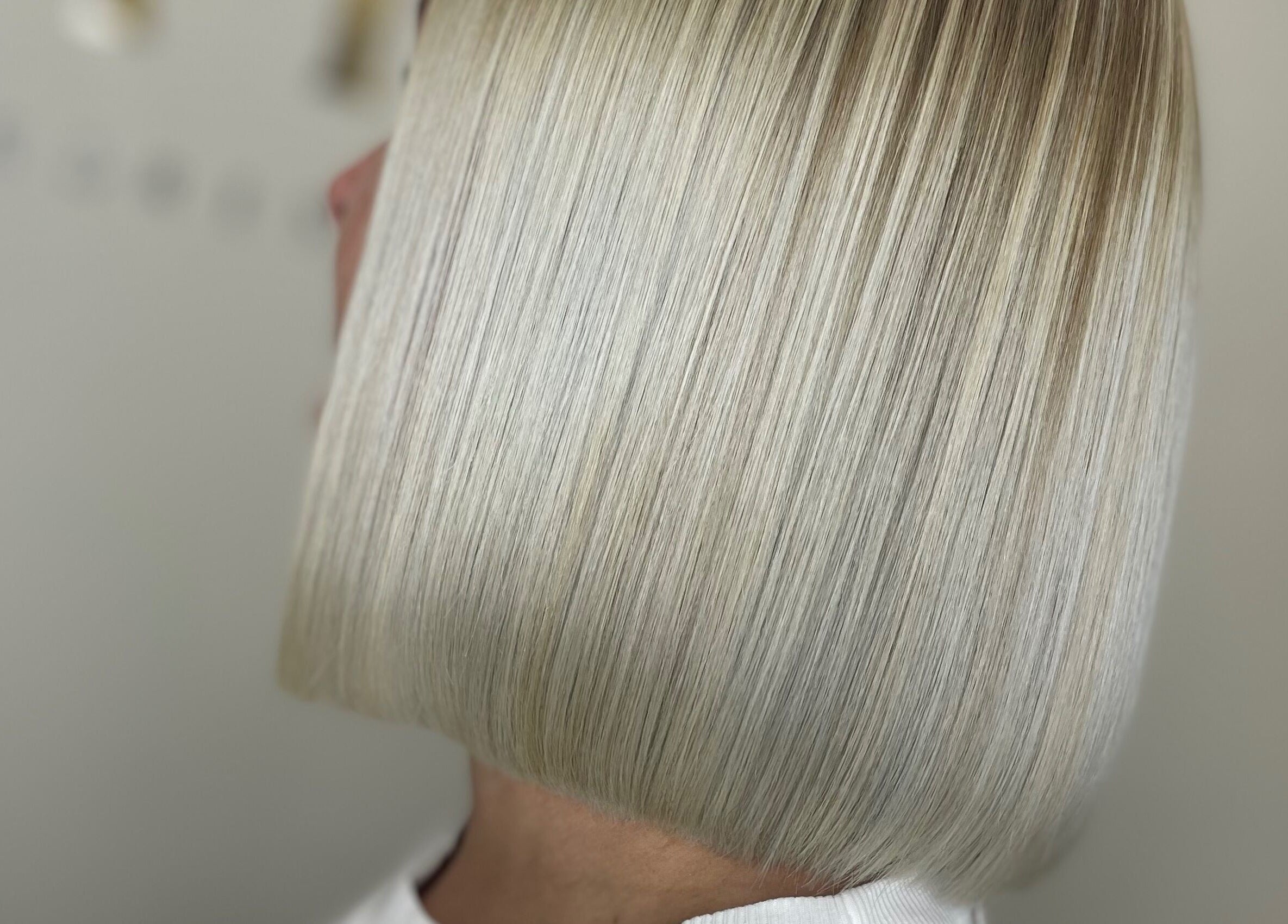 Sleek blonde bob hairstyle at 11:11 Hairdressing in Wrexham, Wales, GB. Modern and professional hair design.