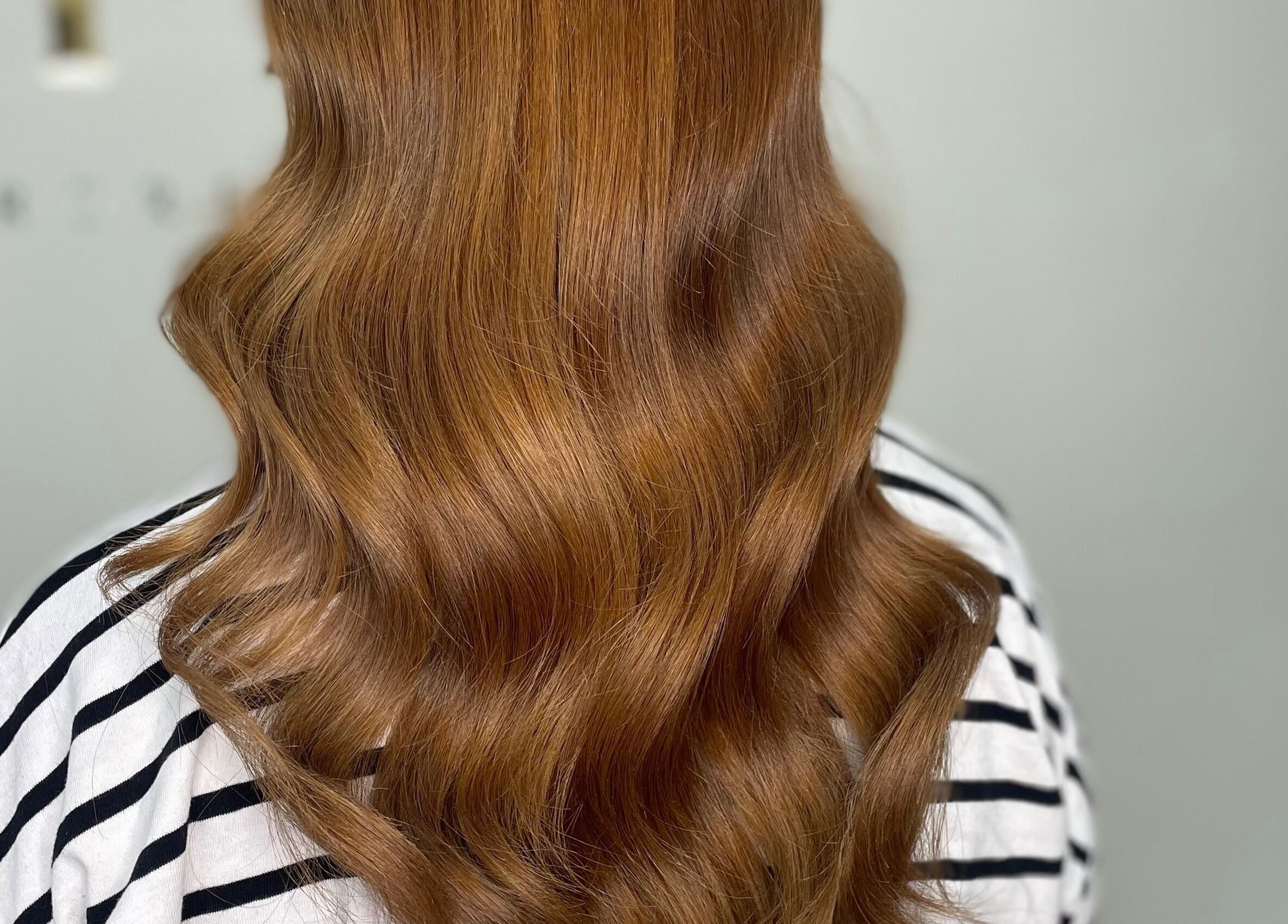 Elegant copper waves hairstyle at 11:11 Hairdressing in Wrexham, Wales, GB.