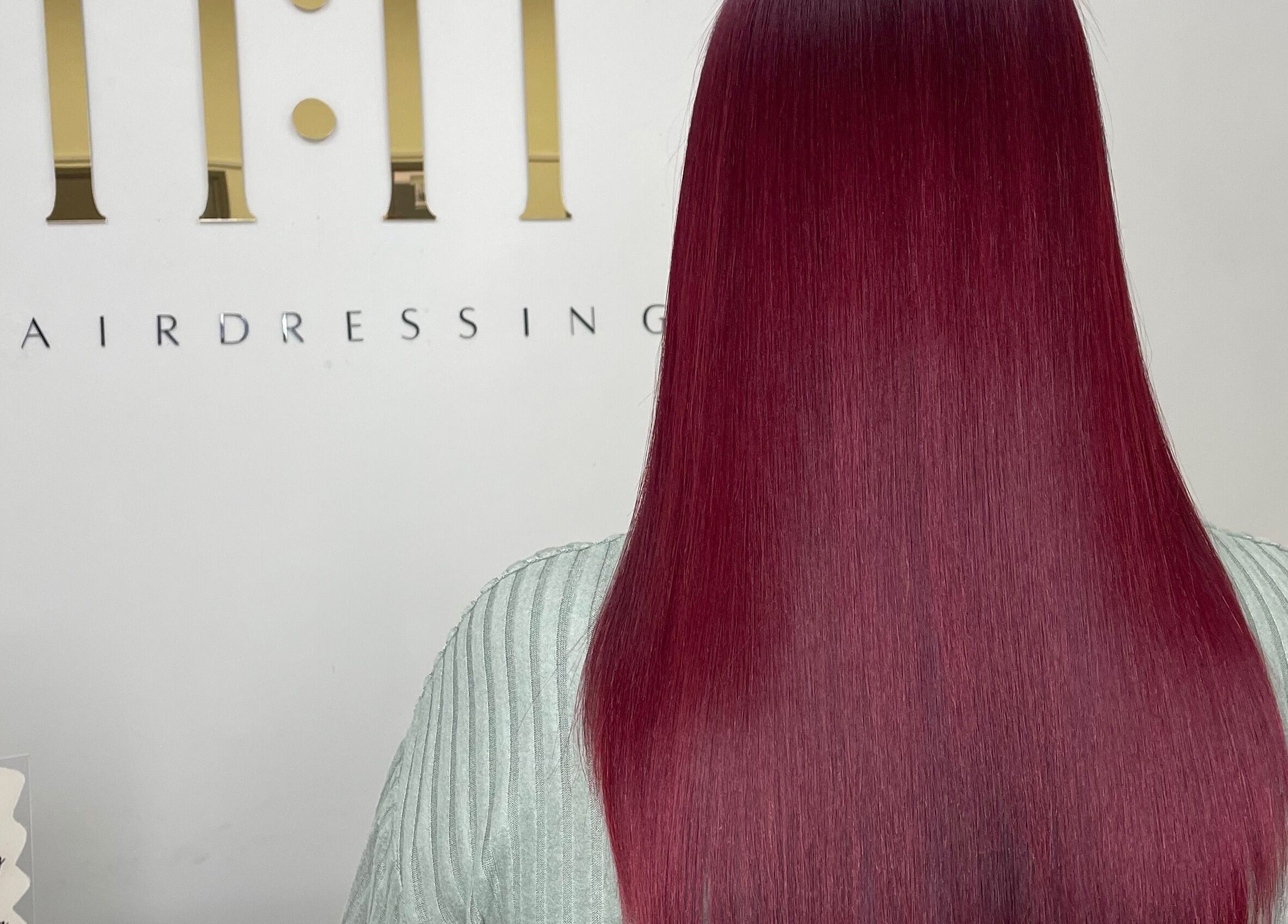 Lush burgundy hair styled at 11:11 Hairdressing in Wrexham, Wales, GB, showcasing sleek and vibrant finish.
