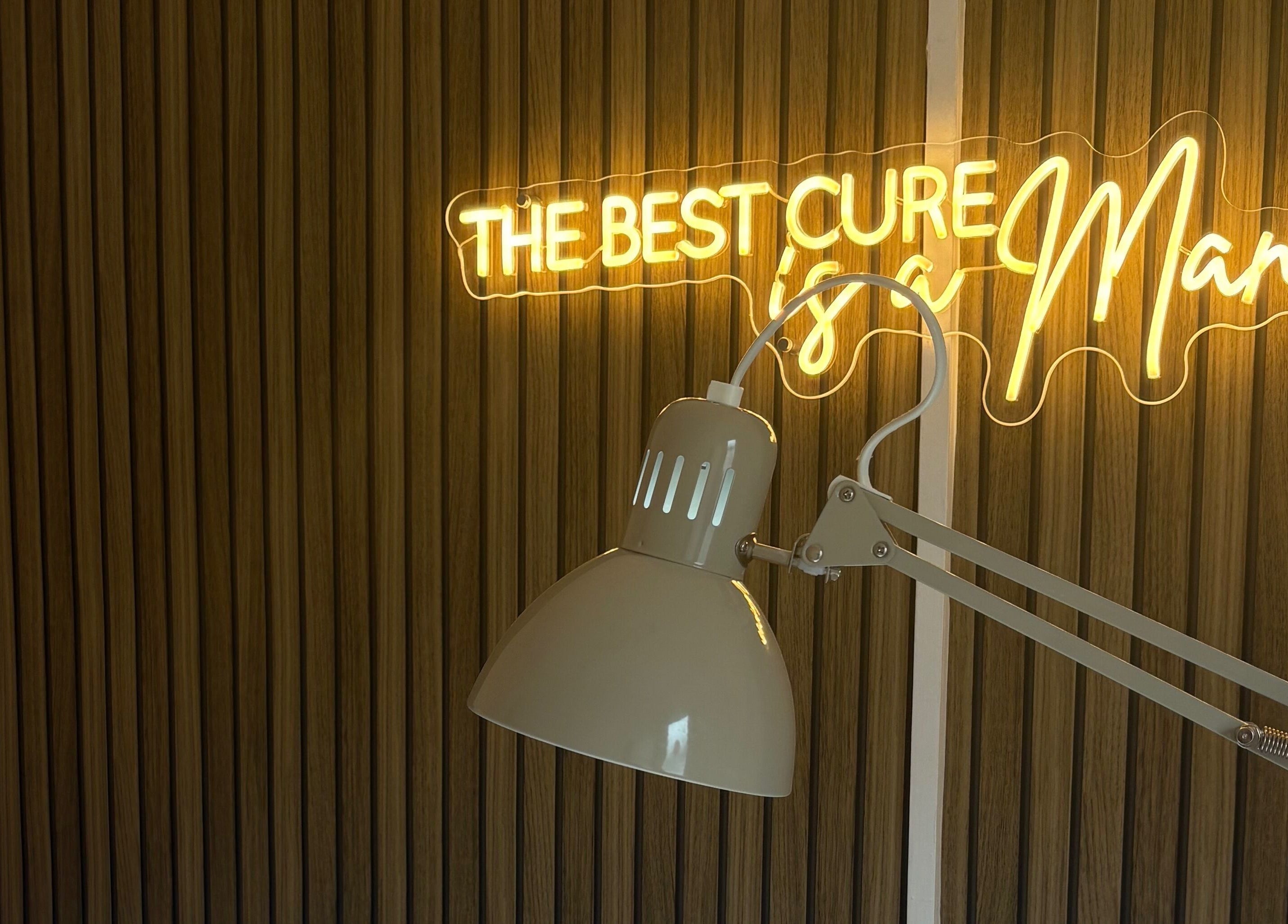 Neon sign and desk lamp at Darc’s Beauty, Frampton Cotterell, England, GB offering a chic ambiance.
