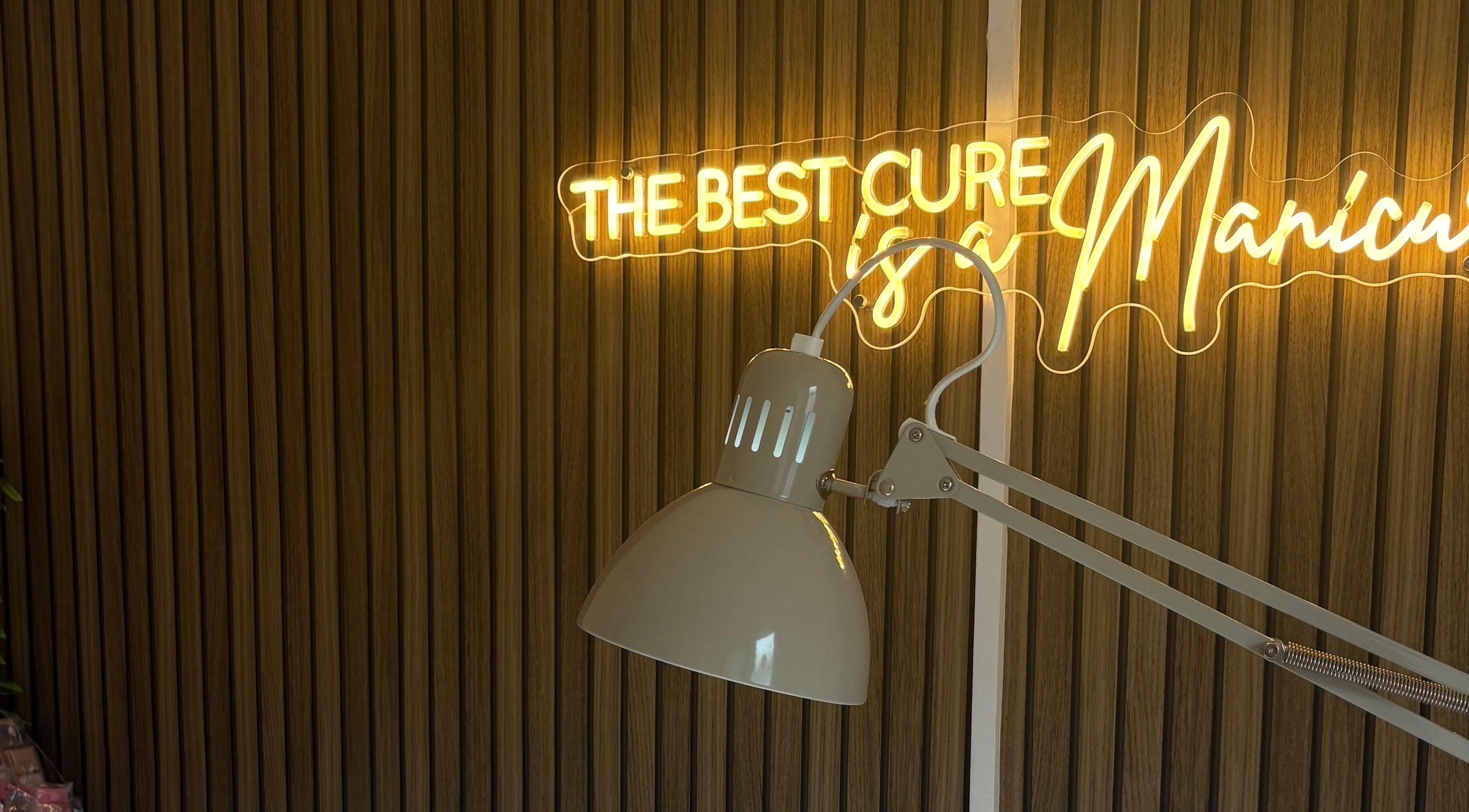 Neon sign and desk lamp at Darc’s Beauty, Frampton Cotterell, England, GB offering a chic ambiance.