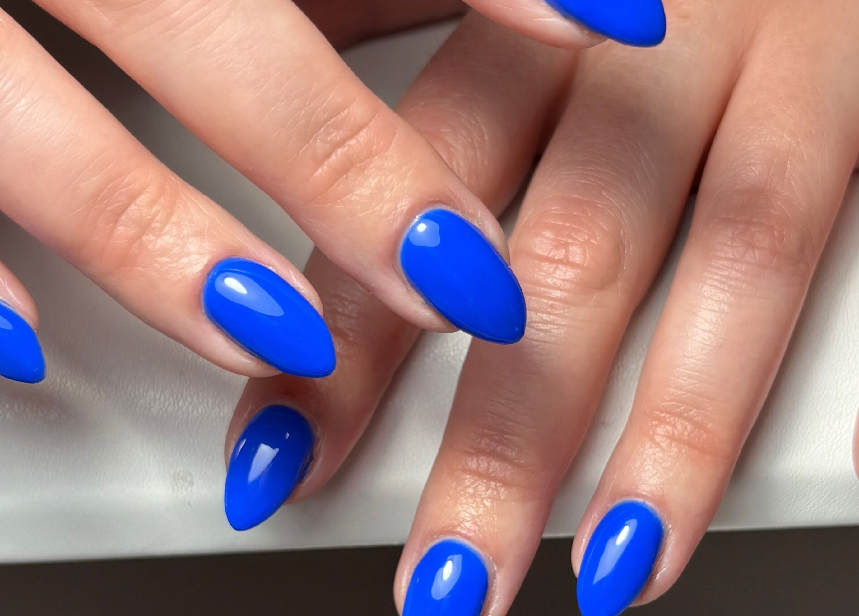 Bright blue manicured nails at Darc’s Beauty, Frampton Cotterell, England, GB offering top beauty services.