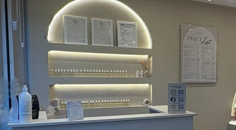 Reception area at Prim and Polished, Bexleyheath, England, GB showcasing certificates and price list.