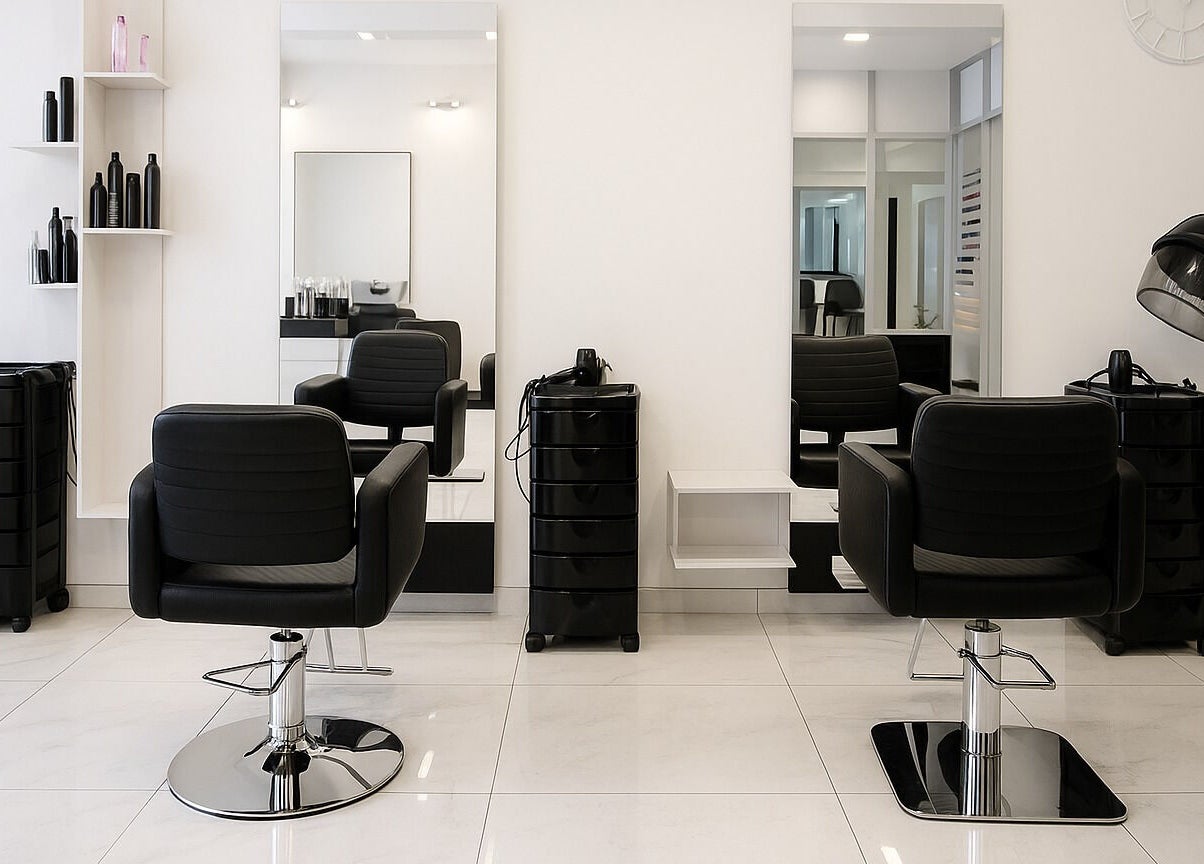 Modern salon interior at Maria Golden Symmetry, Ajax, Ontario, CA with stylish black chairs and mirrors.