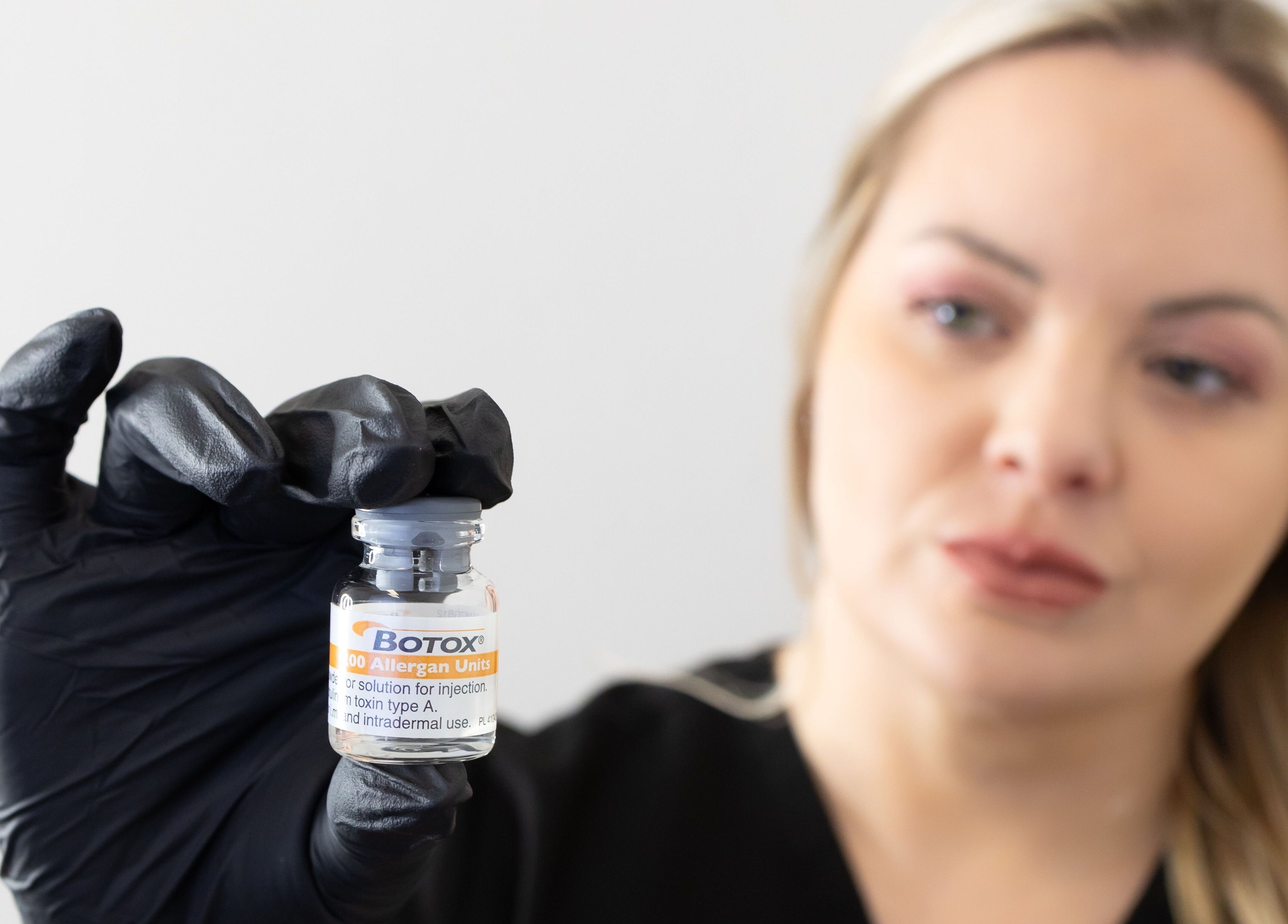 Professional holding Botox vial at Impeccable Aesthetics, Warrington, England, GB, showcasing advanced skincare.