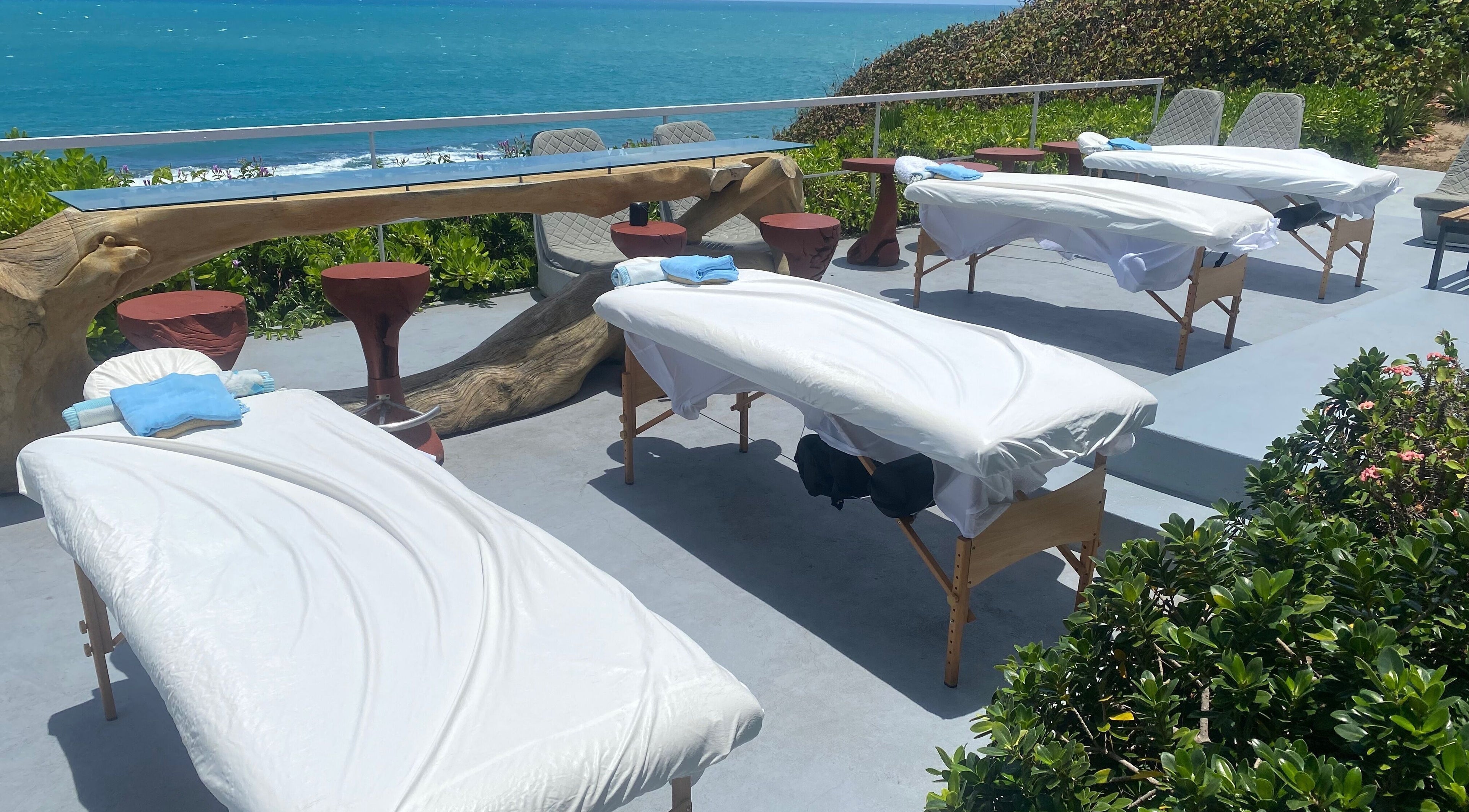 Outdoor massage tables by the ocean at Ocean Serenity Relaxing Massages, Across, Jamaica, JM.