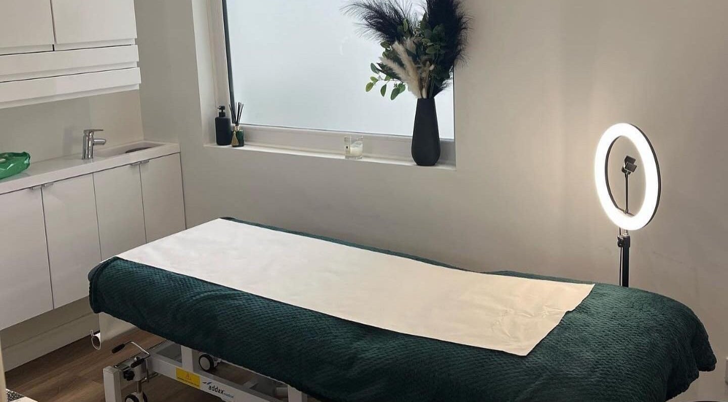 Therapeutic massage room at Black Ivy, Swanley, England, GB with a cozy bed and ambient lighting.