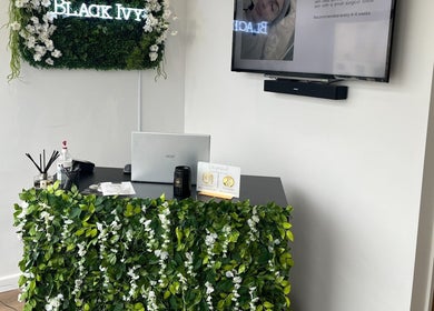 Reception desk at Black Ivy, Swanley, England, adorned with lush green ivy decor.