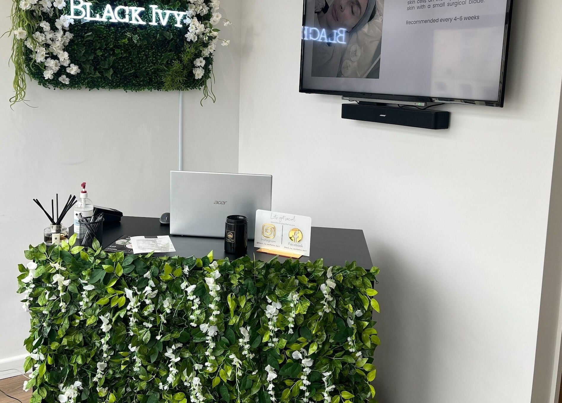Reception desk at Black Ivy, Swanley, England, adorned with lush green ivy decor.