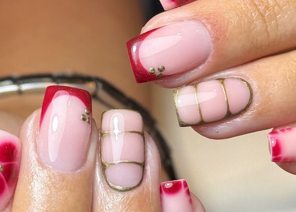 Elegant red and gold nail art at STELLO Beauty Bar, West Dunbartonshire, Scotland, GB. Perfect for stylish looks.