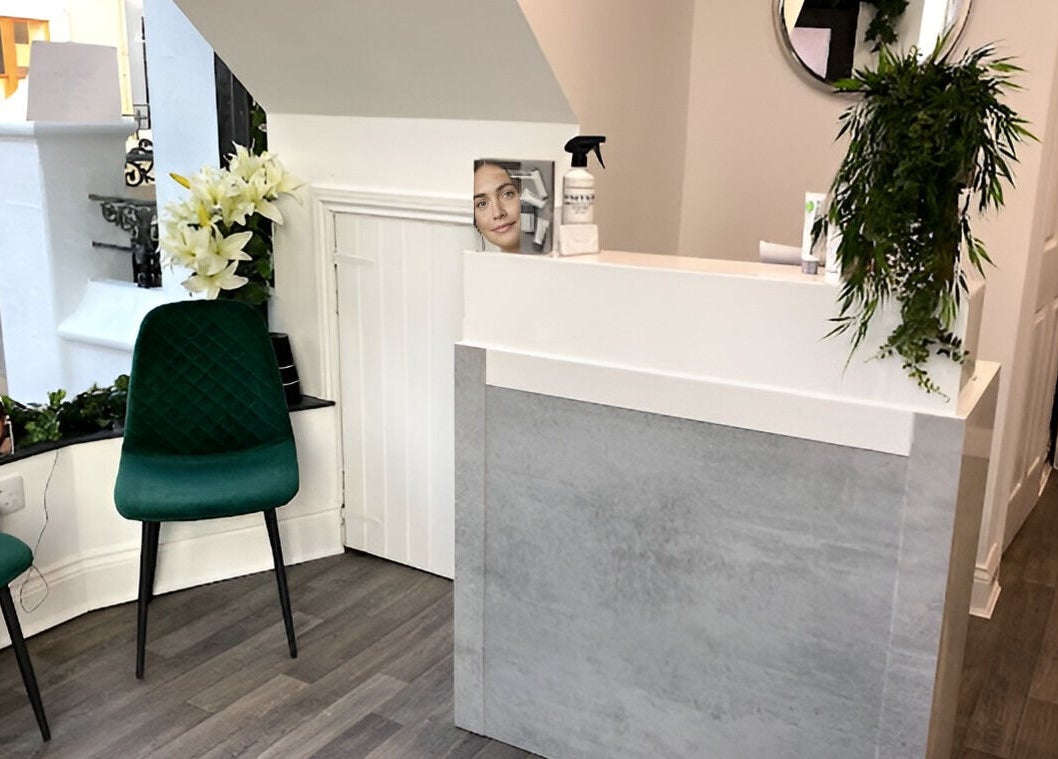 Reception area at The Lily Retreat Skin & Beauty Rooms, Peel, GB featuring elegant decor and seating.