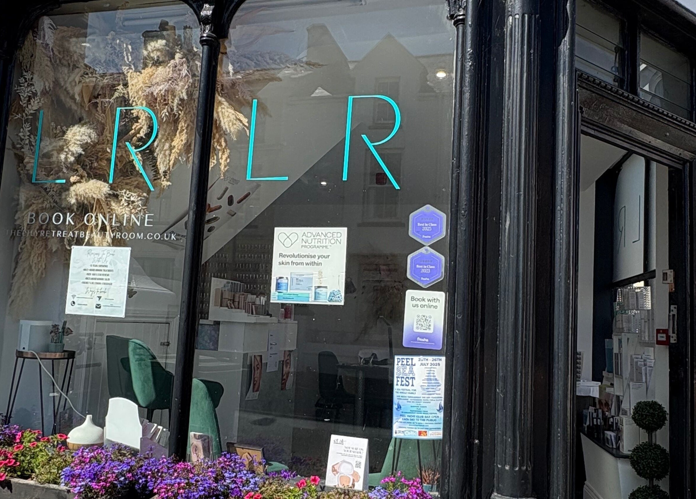 Front view of The Lily Retreat Skin & Beauty Rooms in Peel, GB featuring elegant decor and floral displays.