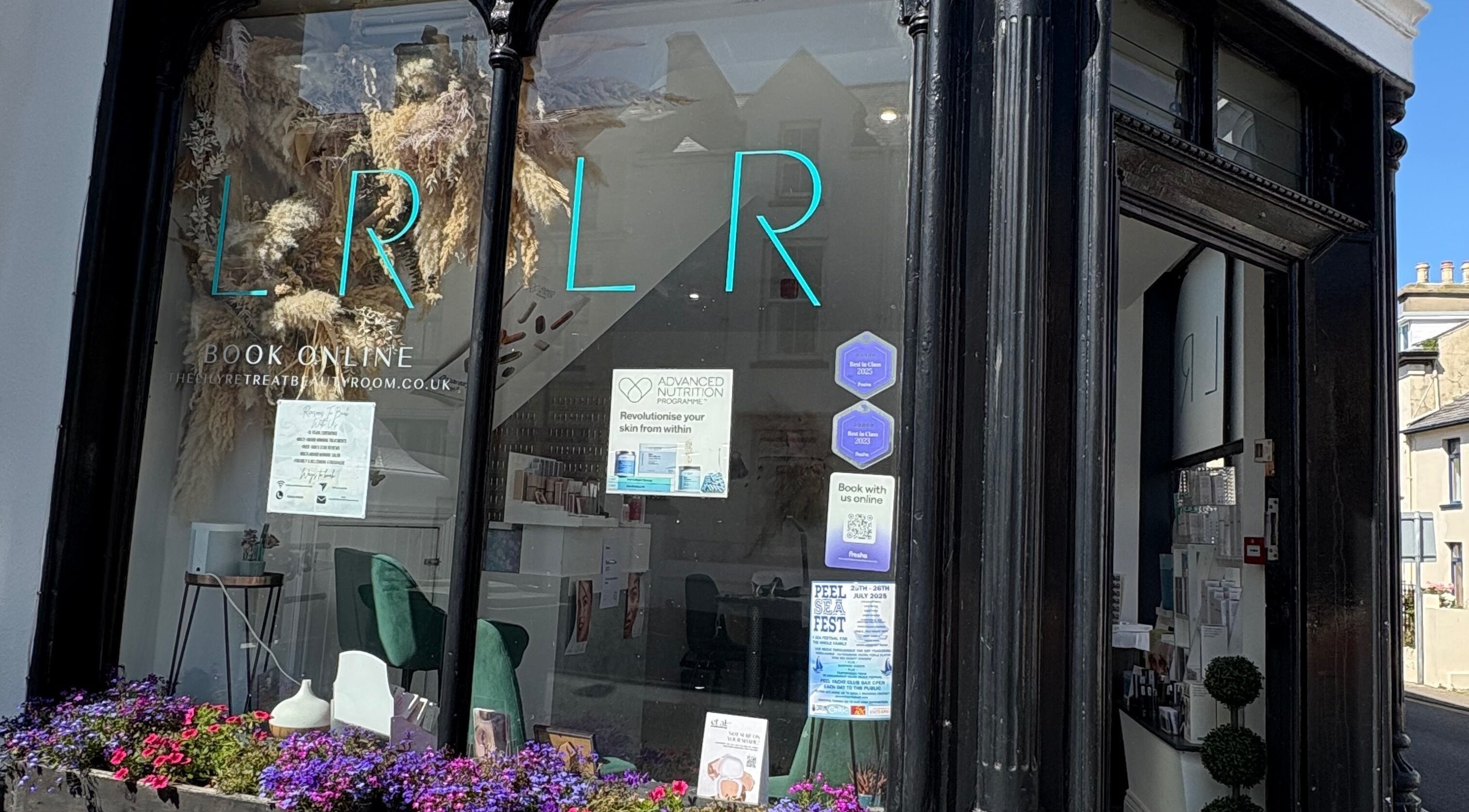Front view of The Lily Retreat Skin & Beauty Rooms in Peel, GB featuring elegant decor and floral displays.