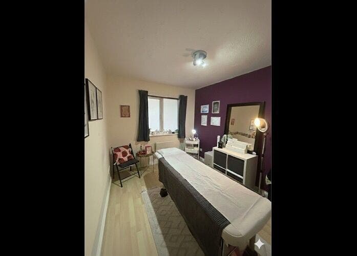 Elegant treatment room at Wax Wurks, Paignton, England, GB, with a massage table and ambient decor.