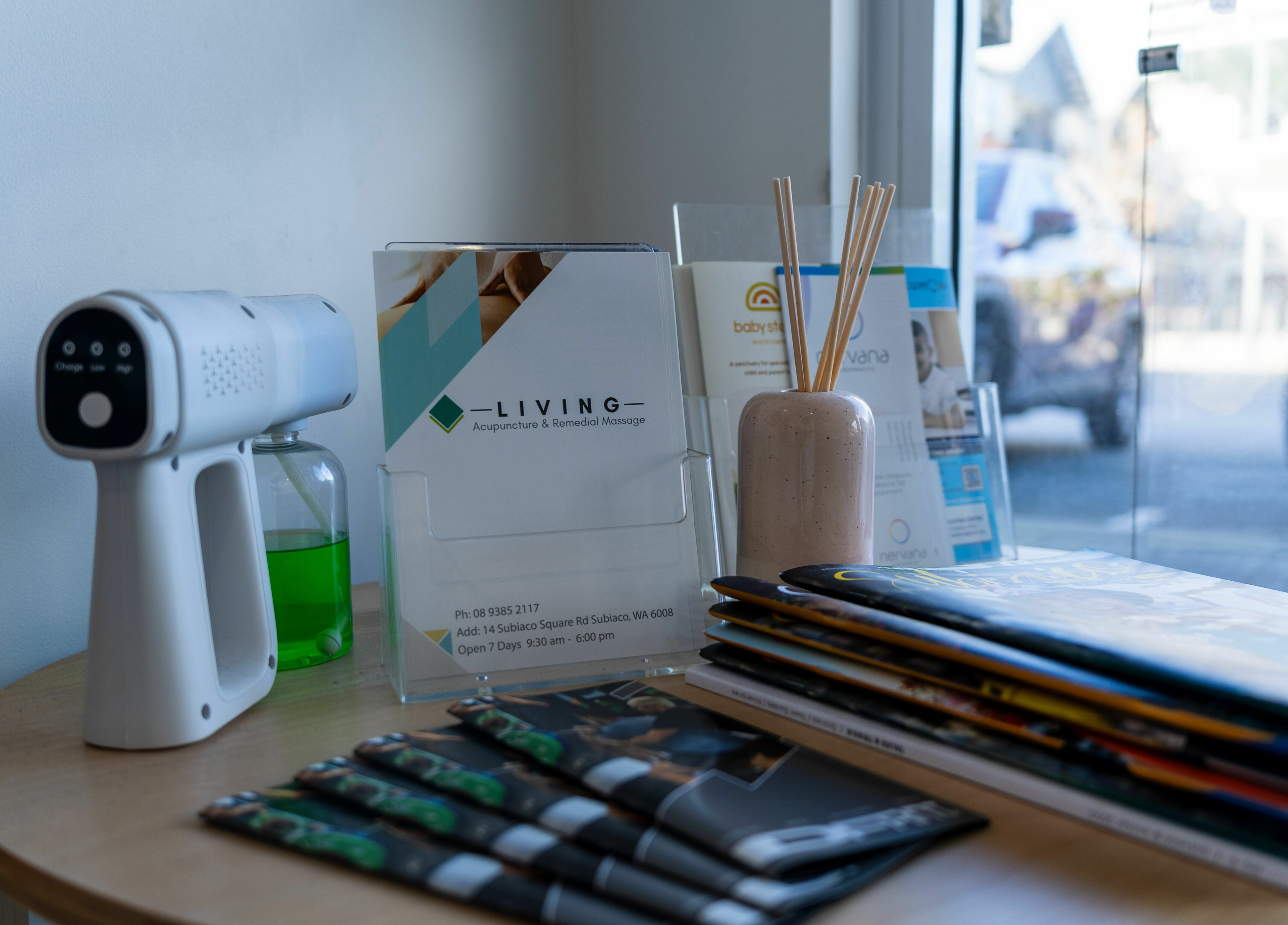 Reception area at Living Acupuncture & Remedial Massage Subiaco, featuring brochures and a reed diffuser.