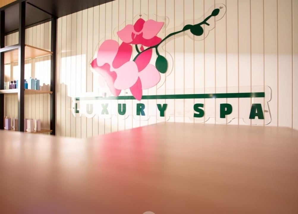 Elegant interior of Luxury Spa, Al Qatif, Eastern Province, SA with floral logo and shelving.