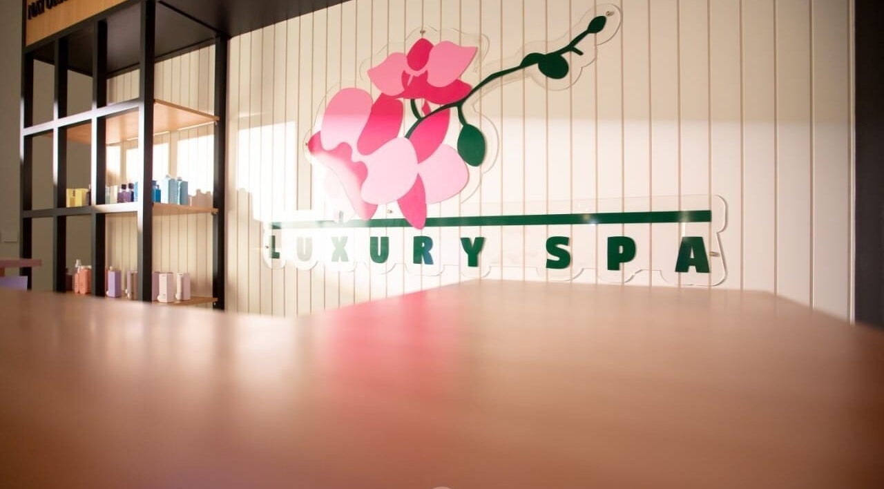 Elegant interior of Luxury Spa, Al Qatif, Eastern Province, SA with floral logo and shelving.