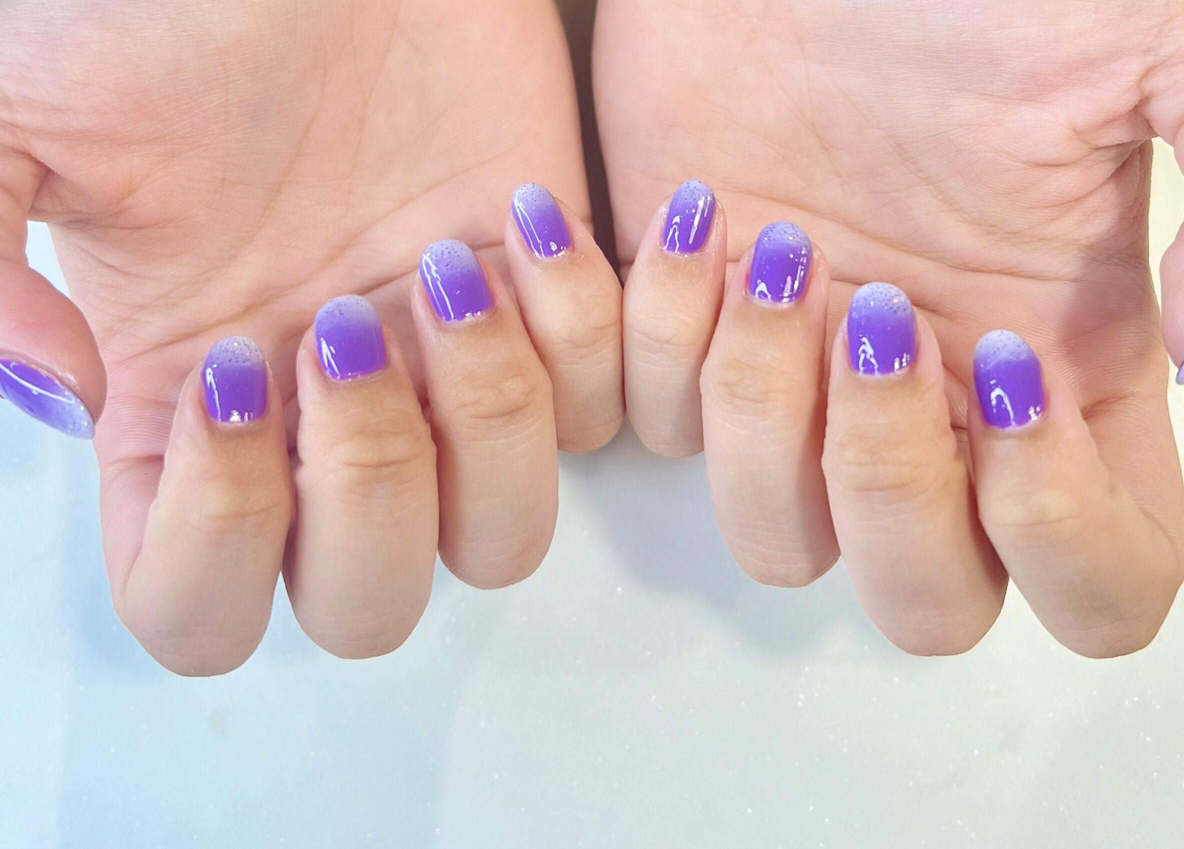 Vibrant purple gradient nails manicure at Luxury Spa, Al Qatif, Eastern Province, SA.