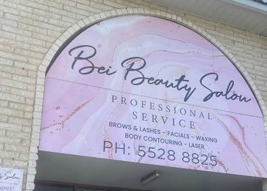 Entrance sign of Bei Beauty Salon in Biggera Waters, Queensland, AU showcasing services like facials and waxing.